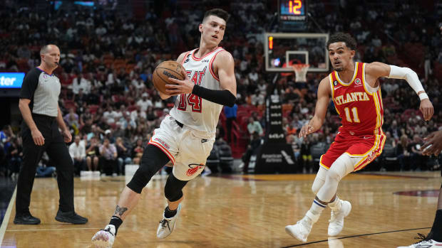 Miami Heat guard Tyler Herro drives past Atlanta Hawks guard Trae Young.
